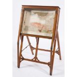 An Edwardian mahogany and brass mounted map display cabinet: of angled form with a hinged top and