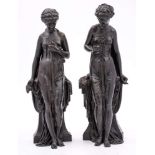 A pair of late 19th Century bronze figures: of neo-classical females draped in robes and leaning