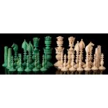 A 19th Century Indian Vizagapatam ivory chess set: one side stained green the other left natural,
