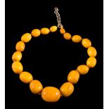 A graduated amber bead single-string necklace: with 19 individually knotted,