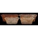 A pair of cast iron garden baskets: of oval outline with interwoven sides and hooped border, 88cm.