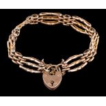 A 9ct gold three-bar, gate-link bracelet: with padlock clasp approximately 12gms gross weight.