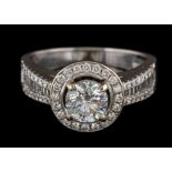 A diamond mounted halo cluster ring: the central brilliant-cut diamond approximately 0.
