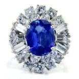 A sapphire and diamond cocktail cluster ring: circa 1950 with central oval blue sapphire 10.
