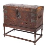 An 18th Century Continental leather covered and steel and brass mounted domed trunk on a later oak