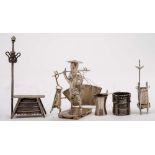 A Chinese silver miniature model of a market seller:, his wares hung from a yoke on his shoulder,