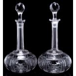 A pair of 19th century cut glass shaft and globe decanters and stoppers: of conventual form with