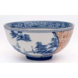 A Chinese copper red and underglaze blue bowl: painted with two cartouches depicting lake