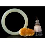 A mixed lot of Chinese jade: comprising a celadon and russet pendant in the form of two peaches,