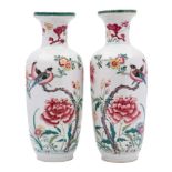 A pair of Chinese famille rose baluster vases: each painted with colourful birds perched on knarled