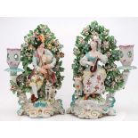 A pair of Derby porcelain figural candlesticks: modelled as a shepherd and companion,