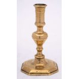 A late 17th/early 18th Century French brass candlestick: with plain cylindrical nozzle on a
