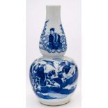 A Chinese blue and white double gourd vase: painted with an equestrian figure and attendants,