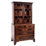 A George III mahogany bookcase on chest:, the upper part with a moulded cornice,
