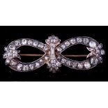 A diamond mounted bow brooch: with loops of graduated old brilliant-cut diamonds estimated to weigh