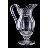 A mid 19th century heavy cut-glass ewer: with pillar cut body and start cut foot, circa 1840, 27cm.