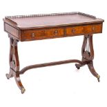 A mahogany rectangular writing table in the Regency taste: with beaded mouldings,