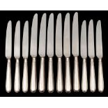 A set of twelve Elizabeth II silver handled table knives and twelve silver handled dessert knives,