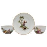 A Meissen tea cup and saucer together with a matching cup: painted with vignettes of male and
