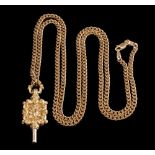 A 9ct gold curb-link chain with attached watch key of foliate design:,