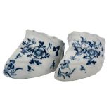 A pair of Liverpool blue and white stirrup cups: painted with insects and peony sprays,