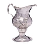 A George III silver embossed pedestal cream jug, maker's mark worn, London,