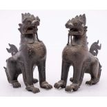 A pair of Burmese bronze mythical beasts: with engraved and inlaid decoration, 19 cm.