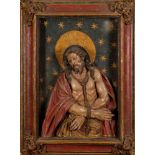 A 17th Century and later carved wood and polychrome decorated high relief panel: depicting Christ