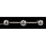A diamond mounted bar brooch: with three principal old-cut diamonds, approximately 1.0cts, 1.