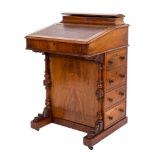 A Victorian walnut and inlaid Davenport:, bordered with lines,