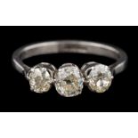 A diamond three-stone ring: set with cushion-shaped old brilliant-cut diamonds approximately 0.
