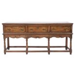 An 18th Century and later oak rectangular dresser base:, the top with a moulded edge,
