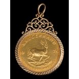 A 1oz Krugerrand dated 1974 mounted as a pendant: within a 9ct gold frame,