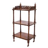A Victorian walnut and inlaid three tier whatnot:,
