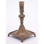 An 18th Century Spanish brass candlestick: with plain cylindrical nozzle on a bulbous knopped stem,