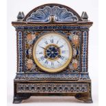 A Doulton Lambeth stoneware cased mantel clock: of architectural outline incised with flowers,