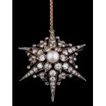 A Victorian pearl and diamond star burst pendant/brooch: the central pearl (untested) approximately