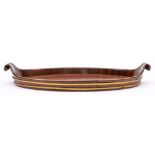 A Georgian mahogany and brass bound tray: of oval outline with scrolling handles to the sides, 67cm.