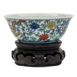 A small Chinese doucai porcelain bowl: the exterior enamelled with a pair of dragons amongst
