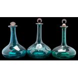 A group of three 19th century green glass Mel bottles and stoppers: each of compressed form with