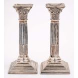 A pair of Elizabeth II silver Corinthian column candlesticks, maker A Taite & Sons Ltd, London,