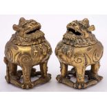 A pair of Chinese bronze incense burners in the form of Qilins: each beast with hinged head and