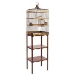 A brass wirework square parrot cage: with slightly domed top and central brass ring handle,