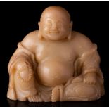 A Chinese soapstone figure of Budai: wearing flowing robes,