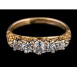 A gold and graduated diamond five-stone ring: set with round old brilliant-cut diamonds estimated