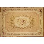 An Aubusson tapestry:, the cream and beige field with a central bouquet of flowers and foliage,