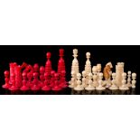 A 19th century ivory chess set of Calvert type: one side stained red the other left natural,