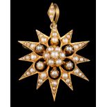 A late 19th /early 20th Century gold and seed pearl star burst pendant brooch: approximately 29mm