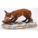 A Meissen figure of a fox and chicken: the standing fox with a chicken in its mouth,