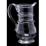 A mid 19th century French glass harvest jug: with ringed neck and loop handle,
